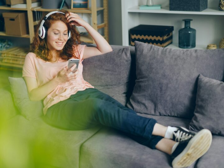 Une jeune femme ecoutant de la musique avec un smartphone.